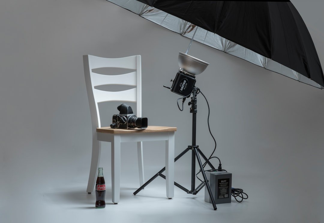 gallery-7 black-video-camera-on-white-wooden-chairs-beside-photo-shooting-umbrella-6iqca9-q-qq