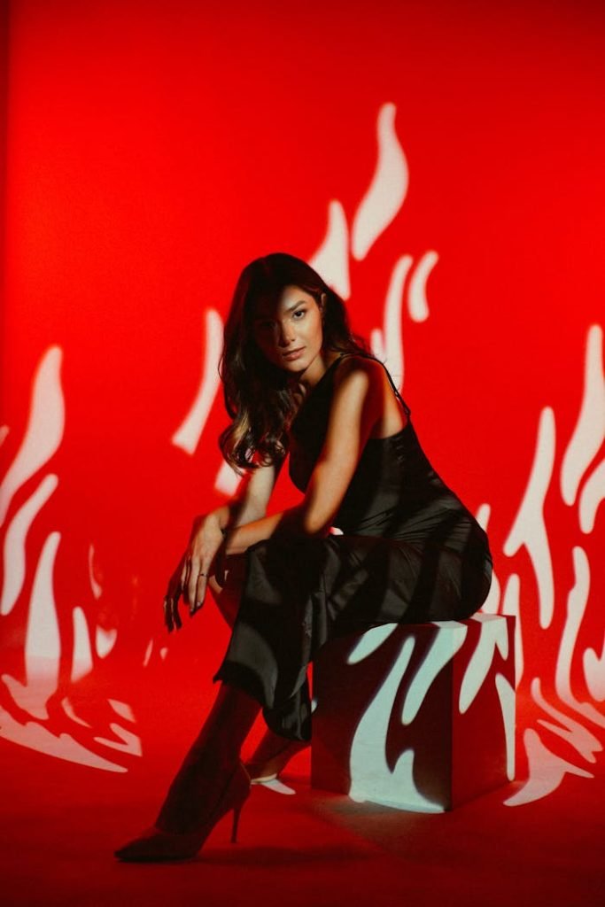 Striking fashion portrait of a model against a creative red backdrop in Baku, Azerbaijan.